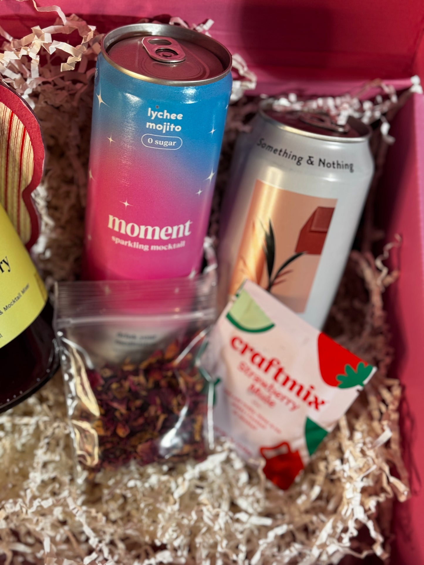 Assorted drinks in a box including 'moment' and 'craftmix' products.