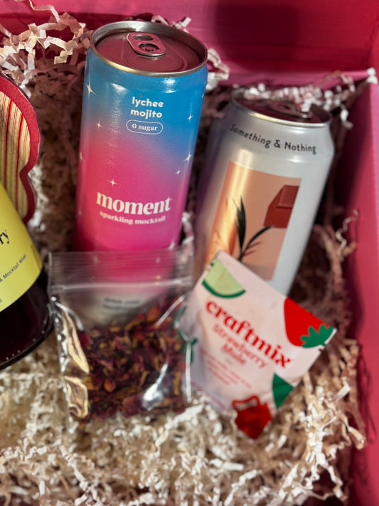 Assorted drinks in a box including 'moment' and 'craftmix' products.